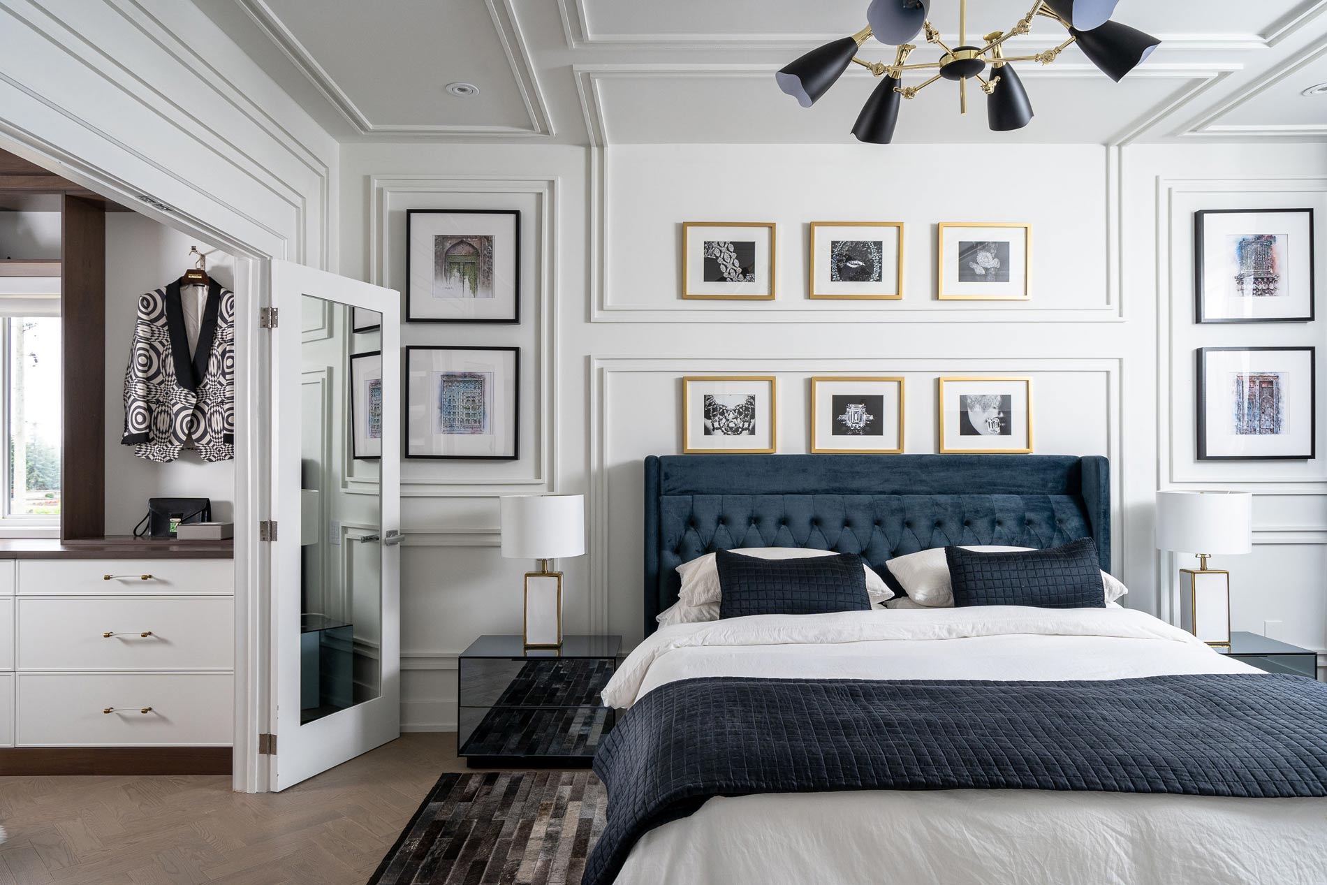 Elegant bedroom with navy tufted headboard and gold-framed artwork